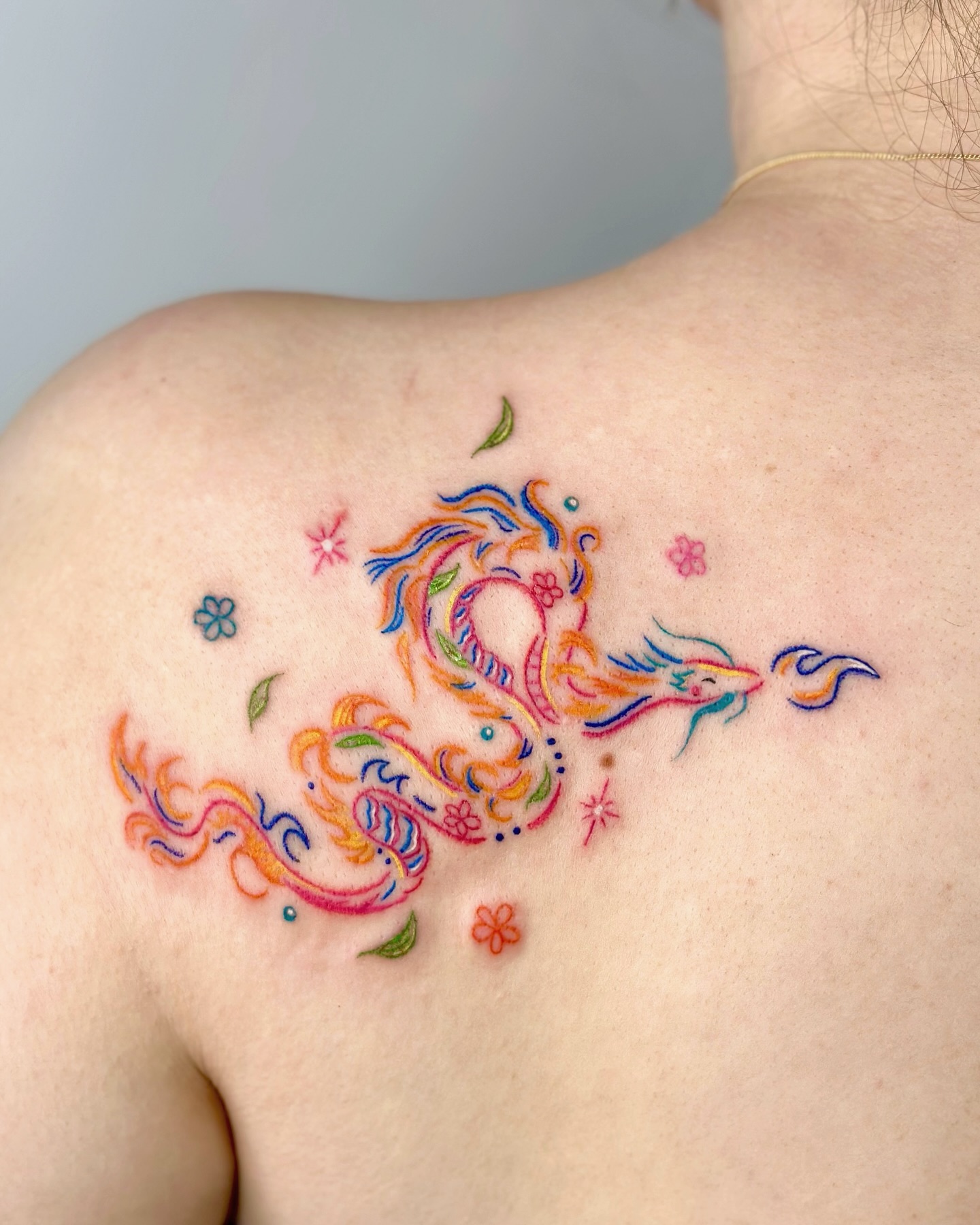12. Colorful Whimsical Dragon Tattoo