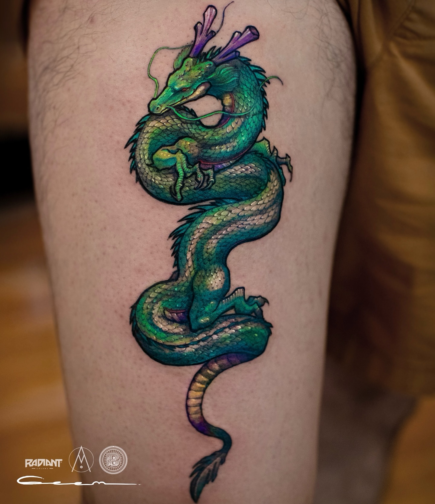 47. Vibrant Emerald Dragon Tattoo