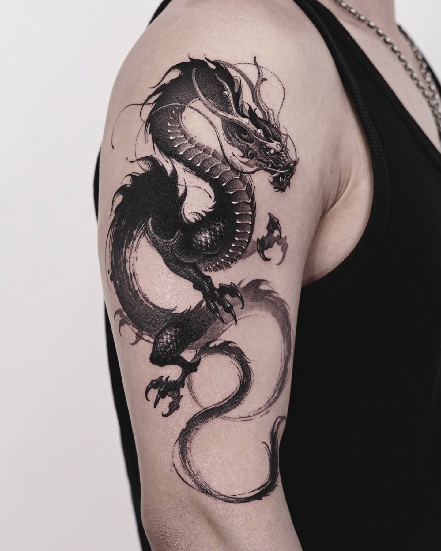 21. Title: Intricate Black and Gray Dragon Tattoo