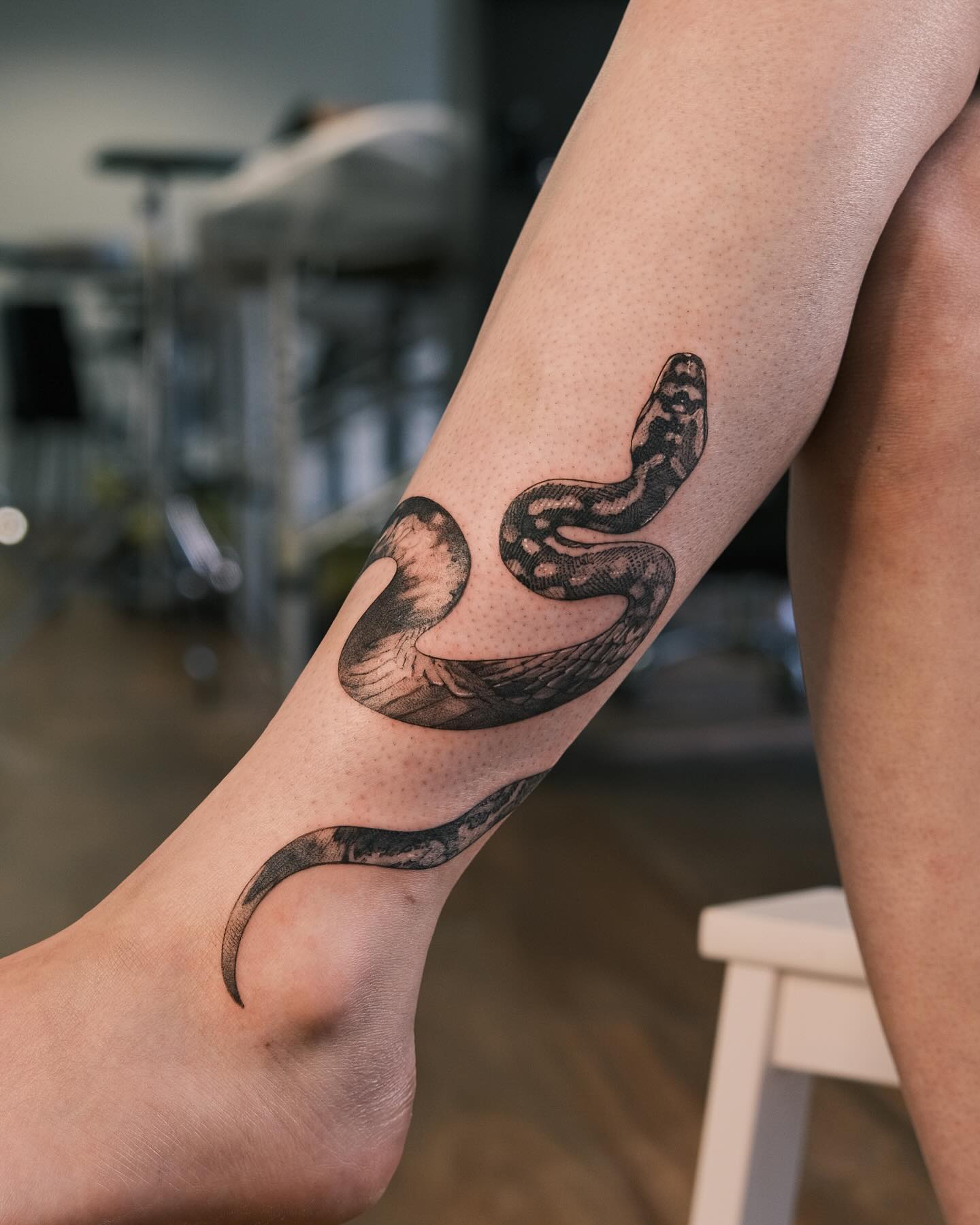 49. Serpent Serendipity: an Ankle Adorned In Inked Elegance